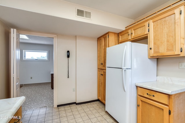 kitchen with white refrigerator and light tile patterned floors