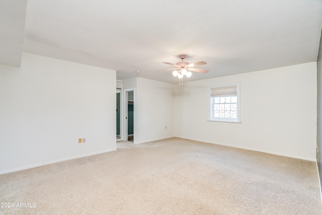 unfurnished room with light carpet and ceiling fan