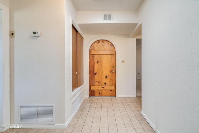 corridor featuring light tile patterned flooring