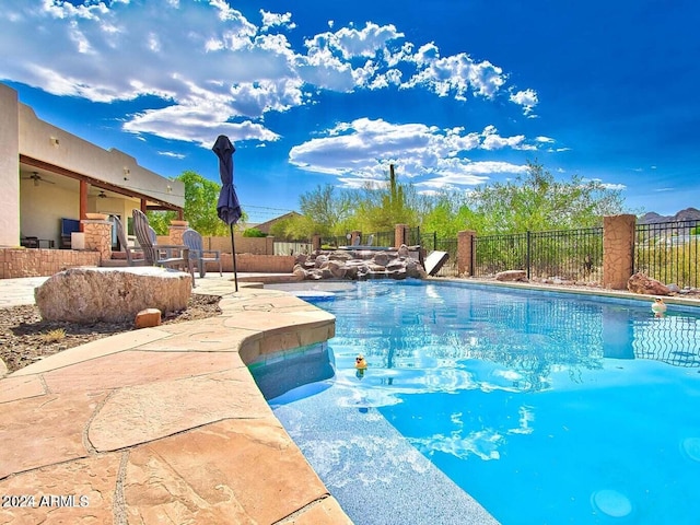 view of pool featuring a patio and ceiling fan