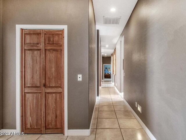 laundry area featuring washer and clothes dryer, light tile patterned floors, cabinets, and sink