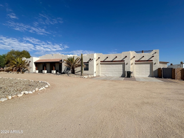 pueblo revival-style home with a garage