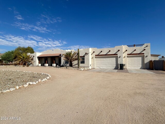 pueblo-style house with a garage