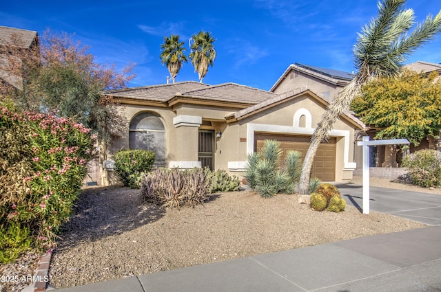 view of front of house featuring stucco siding, concrete driveway, an attached garage, and a tiled roof