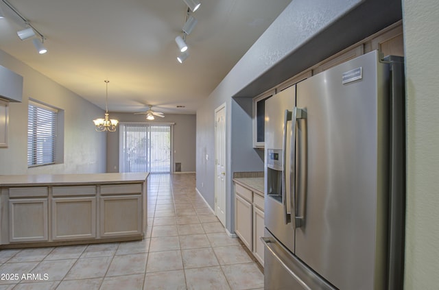 4714 E Paso Trl, Phoenix, AZ 85050 - kitchen with decorative light fixtures, a peninsula, stainless steel fridge with ice dispenser, light countertops, and light tile patterned floors