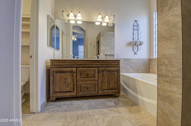 4714 E Paso Trl, Phoenix, AZ 85050 - bathroom featuring ceiling fan, toilet, a garden tub, double vanity, and a sink