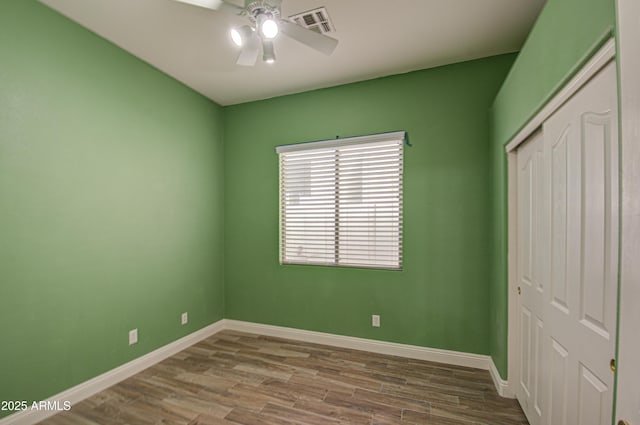 4714 E Paso Trl, Phoenix, AZ 85050 - unfurnished bedroom featuring a closet, visible vents, baseboards, and wood finished floors