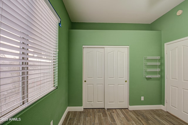 4714 E Paso Trl, Phoenix, AZ 85050 - unfurnished bedroom with a closet, baseboards, and wood finished floors