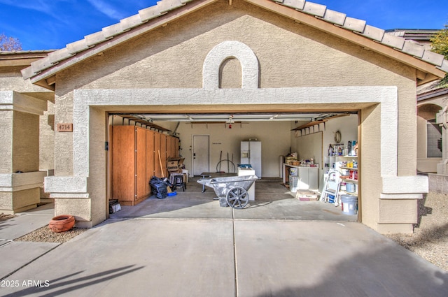 4714 E Paso Trl, Phoenix, AZ 85050 - garage with driveway and white refrigerator with ice dispenser