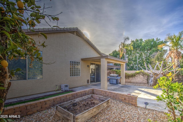 4714 E Paso Trl, Phoenix, AZ 85050 - back of house featuring a garden, stucco siding, fence, and a patio area