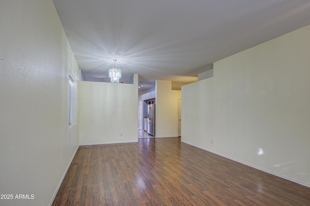 4714 E Paso Trl, Phoenix, AZ 85050 - unfurnished room featuring wood finished floors, baseboards, and a chandelier