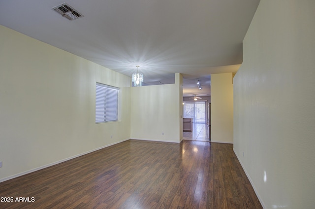 4714 E Paso Trl, Phoenix, AZ 85050 - empty room featuring a notable chandelier, visible vents, baseboards, and dark wood-style flooring