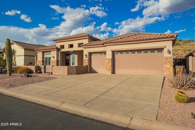 4615 S Primrose Dr, Gold Canyon, AZ 85118 - mediterranean / spanish-style house featuring a tiled roof, driveway, a garage, stone siding, and stucco siding