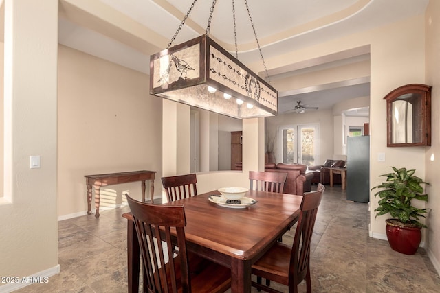 4615 S Primrose Dr, Gold Canyon, AZ 85118 - dining area with baseboards, a ceiling fan, a raised ceiling, and stone finish flooring
