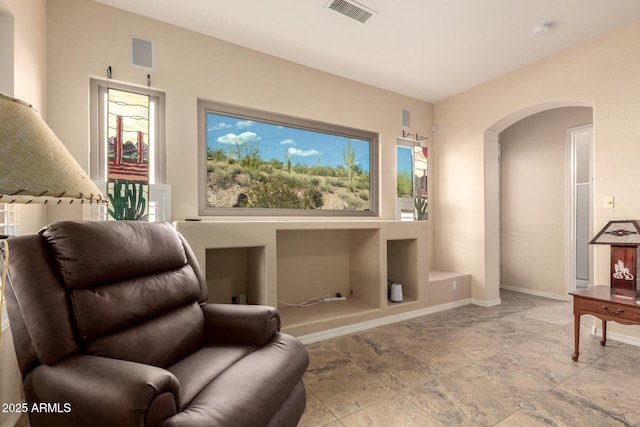 4615 S Primrose Dr, Gold Canyon, AZ 85118 - living area with arched walkways, baseboards, visible vents, and stone tile flooring