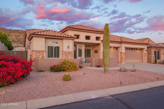 4615 S Primrose Dr, Gold Canyon, AZ 85118 - mediterranean / spanish house with fence private yard, stone siding, stucco siding, concrete driveway, and an attached garage