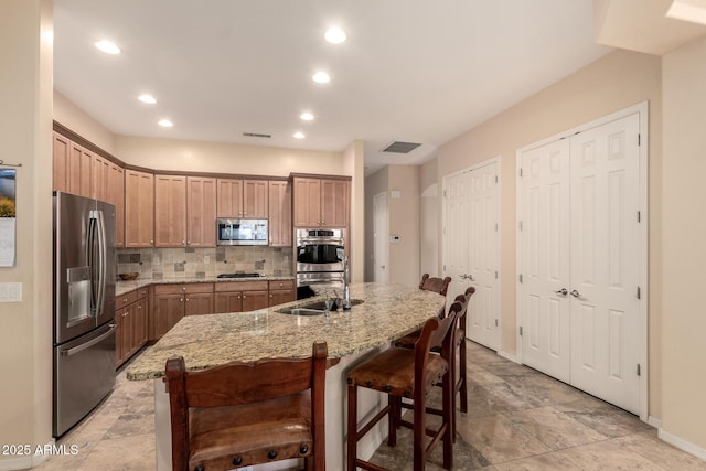 4615 S Primrose Dr, Gold Canyon, AZ 85118 - kitchen with decorative backsplash, a sink, light stone counters, baseboards, and stainless steel appliances