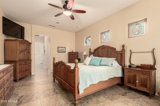 4615 S Primrose Dr, Gold Canyon, AZ 85118 - bedroom with visible vents, arched walkways, ceiling fan, and stone finish floor