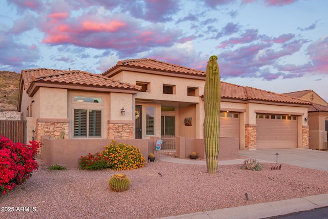 4615 S Primrose Dr, Gold Canyon, AZ 85118 - mediterranean / spanish home with driveway, fence, an attached garage, stone siding, and stucco siding