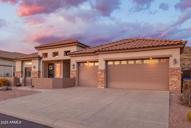 4615 S Primrose Dr, Gold Canyon, AZ 85118 - mediterranean / spanish-style home with a garage, fence, concrete driveway, stone siding, and stucco siding