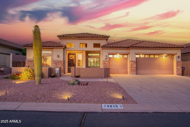 4615 S Primrose Dr, Gold Canyon, AZ 85118 - mediterranean / spanish-style home featuring stucco siding, concrete driveway, stone siding, and a garage