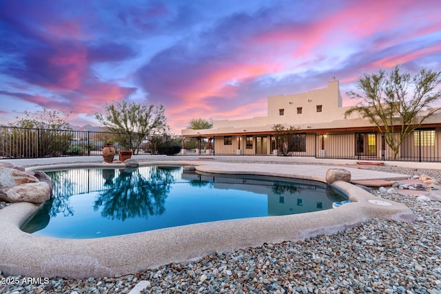 pool at dusk with a patio