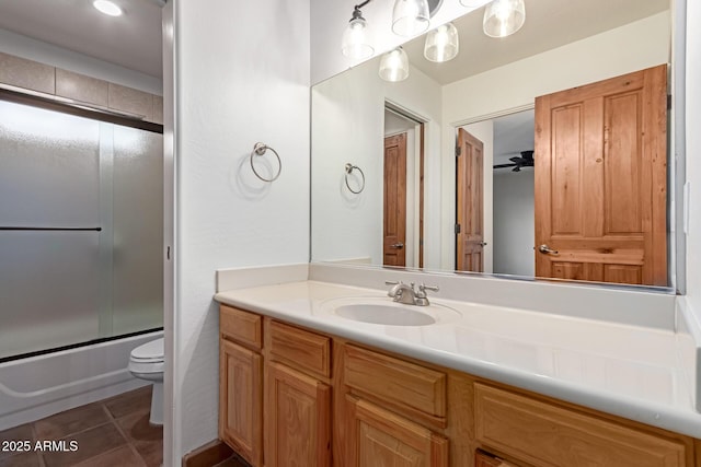 full bathroom with tile patterned flooring, enclosed tub / shower combo, vanity, and toilet