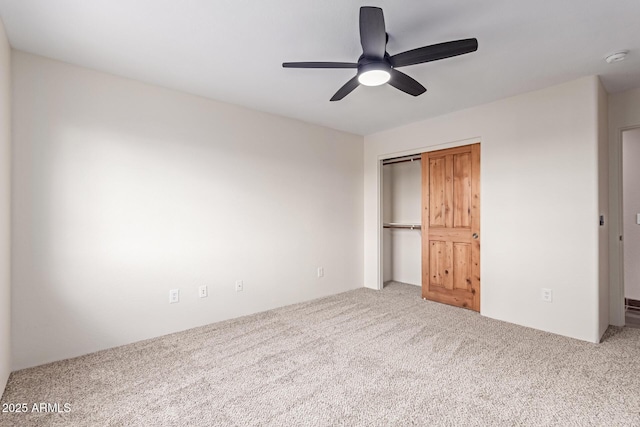 unfurnished bedroom featuring carpet floors, ceiling fan, and a closet