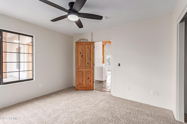 unfurnished bedroom with light carpet and ceiling fan