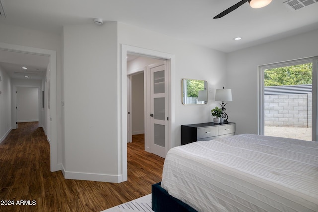 bedroom with dark hardwood / wood-style flooring and ceiling fan