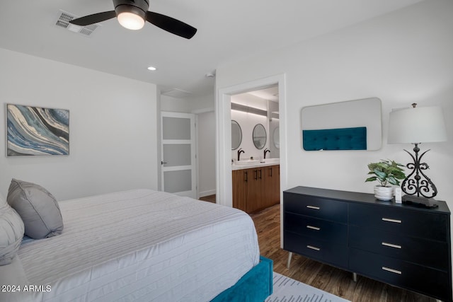 bedroom featuring dark wood-type flooring, sink, ceiling fan, and ensuite bath