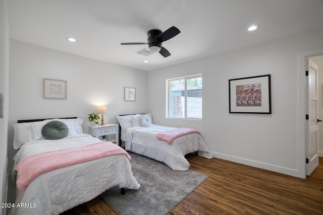 bedroom with dark hardwood / wood-style floors and ceiling fan