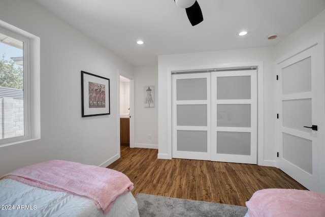 bedroom featuring dark wood-type flooring, ceiling fan, and a closet