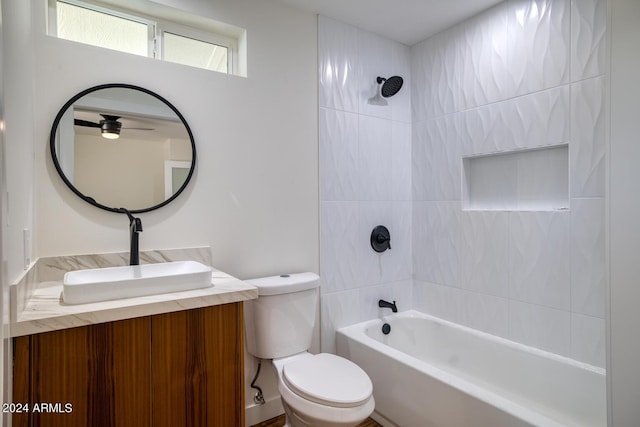 full bathroom with tiled shower / bath combo, vanity, and toilet