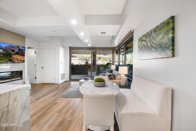 sitting room with light hardwood / wood-style floors and french doors