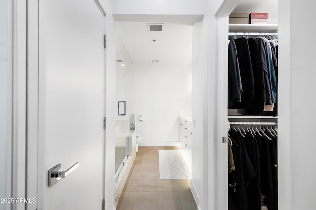 bathroom featuring walk in shower, tile patterned floors, toilet, and vanity