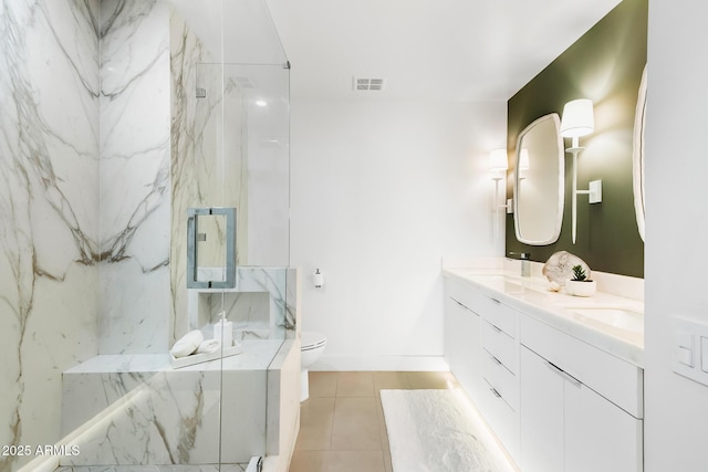 bathroom featuring vanity, toilet, tile patterned flooring, and a shower