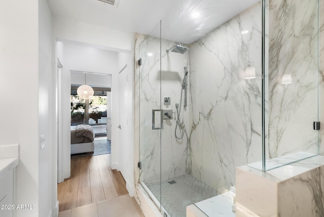 bathroom with vanity and a shower with door