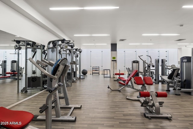 workout area with hardwood / wood-style flooring