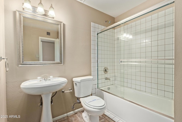1874 E Huntington Dr, Tempe, AZ 85282 - full bathroom with toilet, combined bath / shower with glass door, tile patterned floors, and baseboards