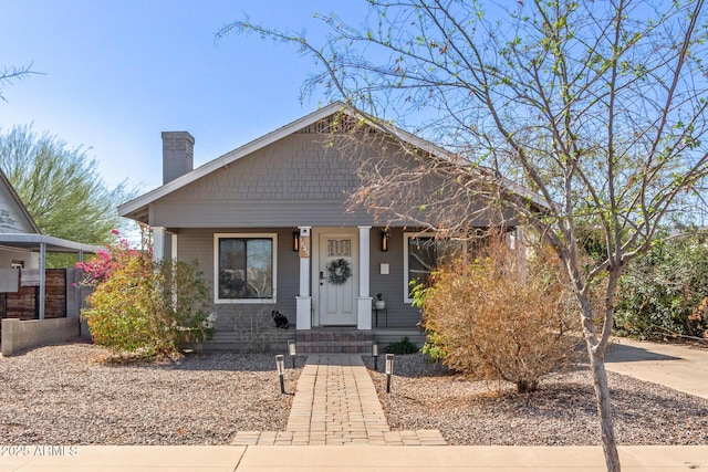 bungalow-style house featuring a chimney