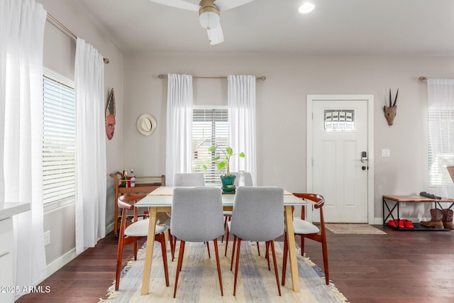 dining area with baseboards and wood finished floors