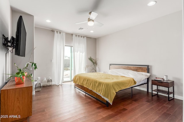 bedroom featuring access to exterior, recessed lighting, and wood finished floors