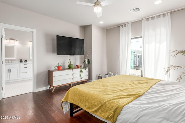 bedroom with visible vents, baseboards, dark wood-style flooring, ensuite bathroom, and access to outside