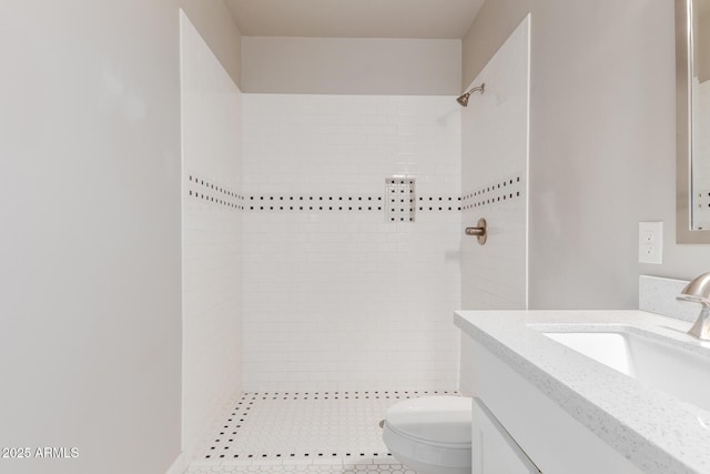 full bathroom with vanity, toilet, and tiled shower