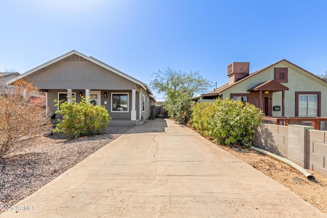 view of front of property with fence and central AC