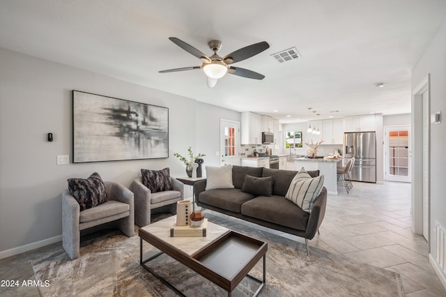 tiled living room featuring ceiling fan