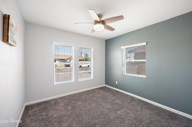 carpeted spare room with ceiling fan