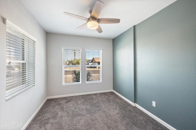 carpeted empty room featuring ceiling fan