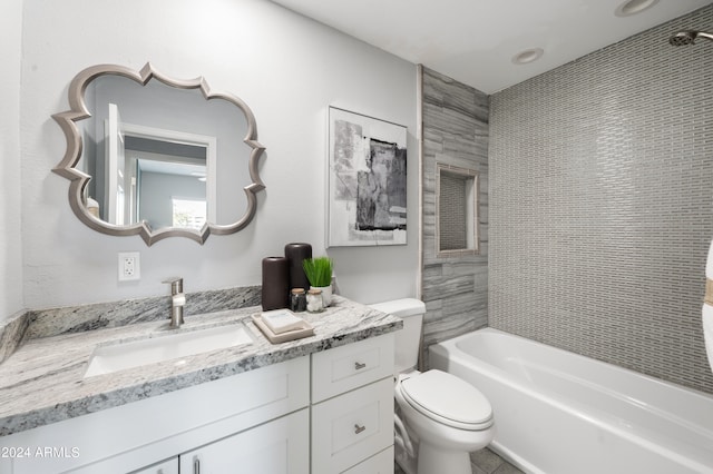 full bathroom featuring vanity, toilet, and tiled shower / bath